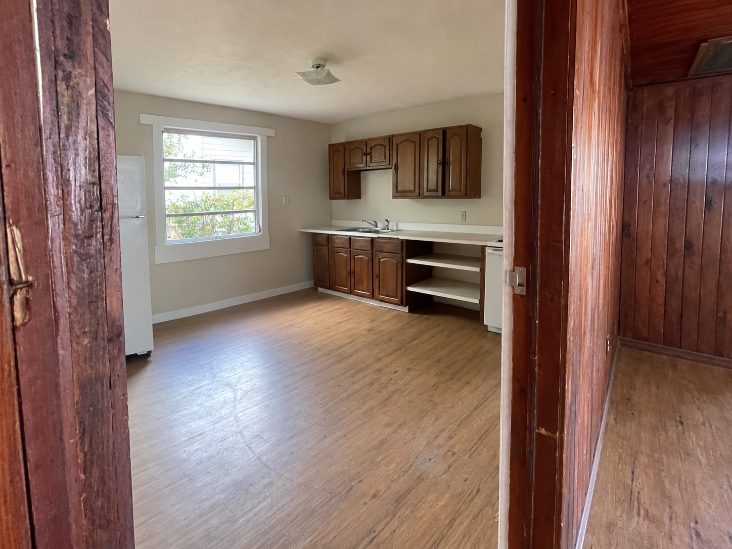 Kitchen before renovation — original cabinets and flooring